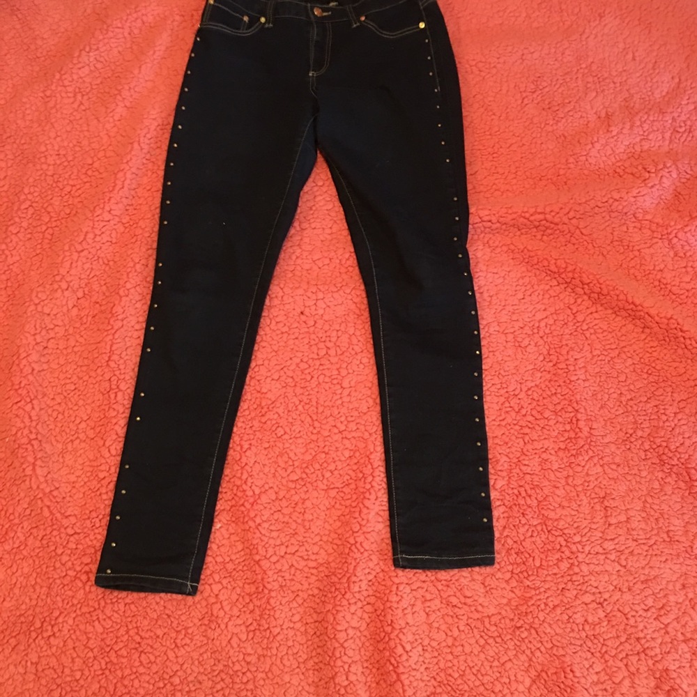 Dark blue jeans with studs down the sides